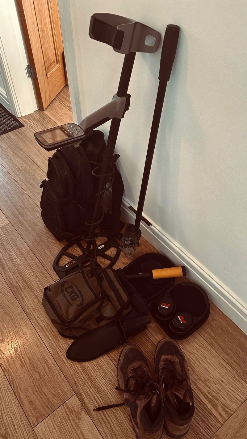 My detecting kit stood by the door: a Minelab X-Terra Elite with its coil, a digging spade, a pinpointer, finds bag, backpack, Minelab headphones and a pair of well-worn walking boots.